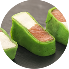 Green pancake roll with salmon and soft cheese