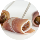 Date with ham and pine nuts on a skewer