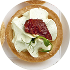 Tartlets with sun-dried tomatoes, soft cheese and pesto